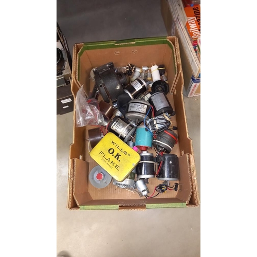 146 - A box of transformers, electric motors and electric clock cases, movements etc COLLECT ONLY