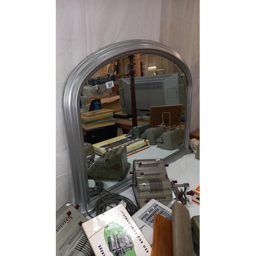 207 - An arched top overmantel mirror in silver coloured frame, COLLECT ONLY.