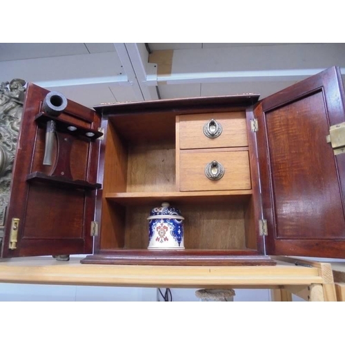 1187 - A mahogany smokers cabinet with ceramic tobacco jar.