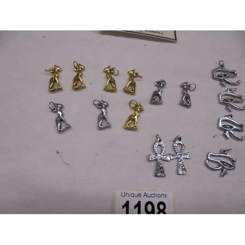 1198 - A quantity of Egyptian pendants including 2 silver Goddess Bastet, Eye of Horus etc.,