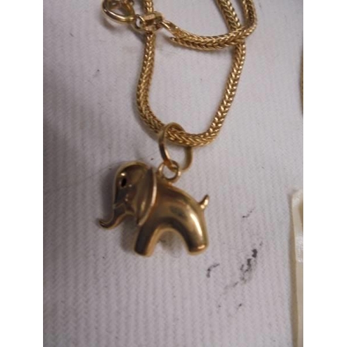 1150A - An 18ct gold elephant pendant on 18ct gold chain with spare length of 18ct gold chain, 15.18 grams.