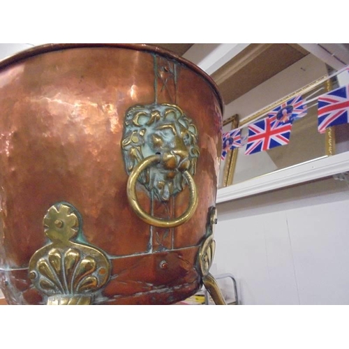 1213 - A brass and copper cauldron with lion head handles and lion paw feet. COLLECT ONLY.