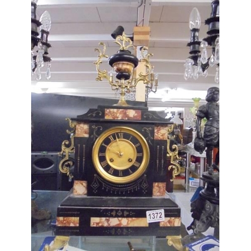 1372 - A Victorian three piece clock garniture, the clock in marble and the side pieces being candelabra su... 