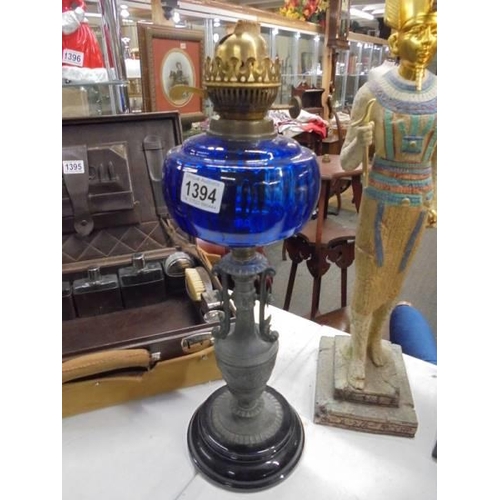 1394 - A Victorian oil lamp on spelter base and column with blue glass font. COLLECT ONLY.