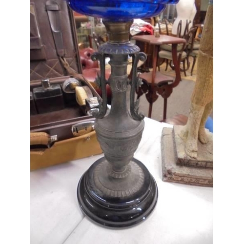 1394 - A Victorian oil lamp on spelter base and column with blue glass font. COLLECT ONLY.