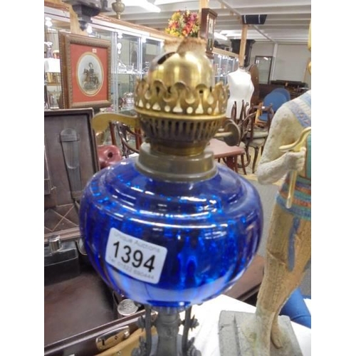 1394 - A Victorian oil lamp on spelter base and column with blue glass font. COLLECT ONLY.