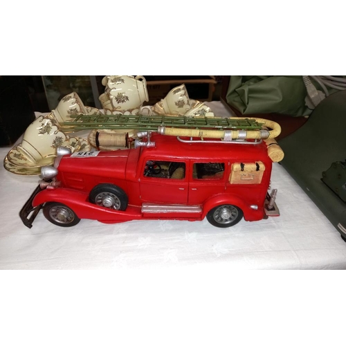 215 - A large pressed steel and fibre glass model of a vintage American fire engine length 36cm