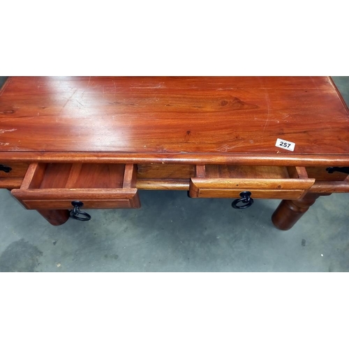 257 - A dark wood stained rustic coffee table with iron fittings and 2 drawers