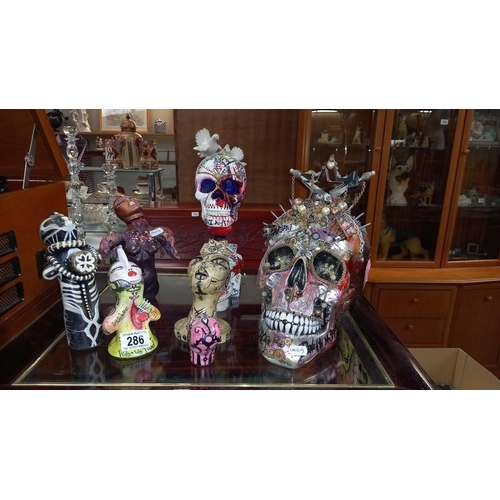 286 - 2 skull ornaments and other figures including picture by artist Joanna Weir COLLECT ONLY