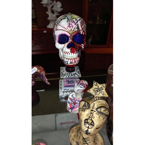 286 - 2 skull ornaments and other figures including picture by artist Joanna Weir COLLECT ONLY