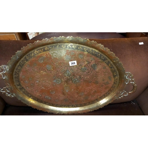 369 - A large Eastern brass tray with coloured infilled engraved top and an inlaid tray, possibly made wit... 