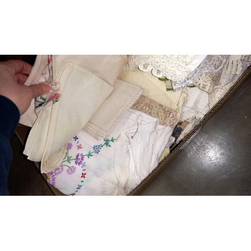 381 - A box of linens and doilies etc