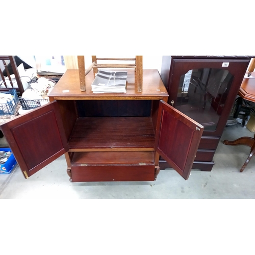 386 - A modern solid wood TV cabinet. Opening doors over drop down front. Collect Only.