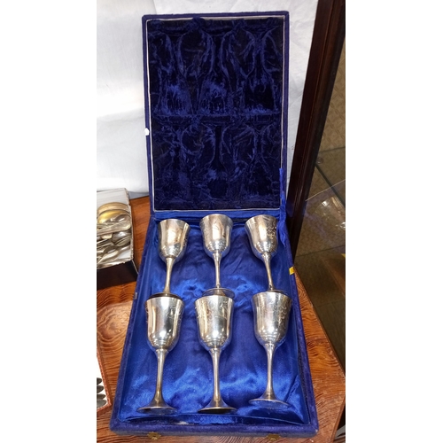 395 - A boxed set of Cavalier silver plated coasters, goblets set, boxed cutlery etc