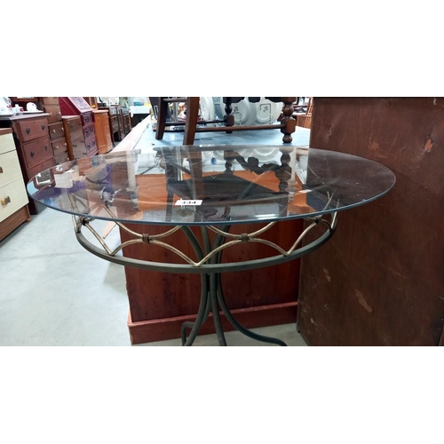 434 - A smoked glass top wrought iron garden table, COLLECT ONLY