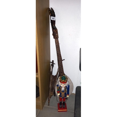 445 - A tourist tribal one string 'guitar', oak bellows and a German soldier nutcracker