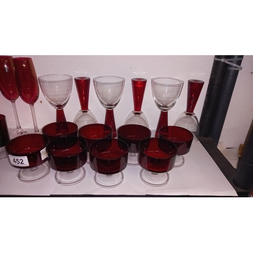 452 - A good lot of red glass including champagne flutes, sundae dishes etc