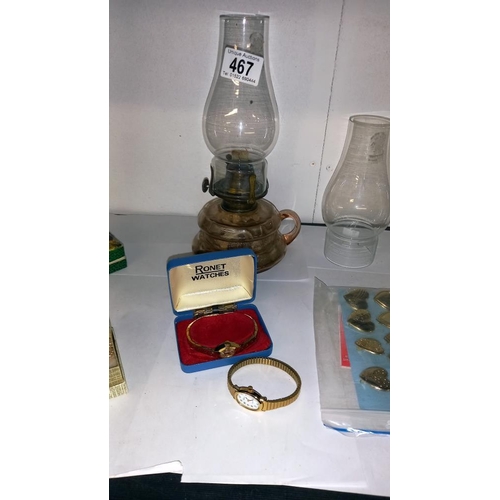 467 - A mixed lot including oil lamp with chimneys, boxed harmonica, watches, RAF tie pin etc