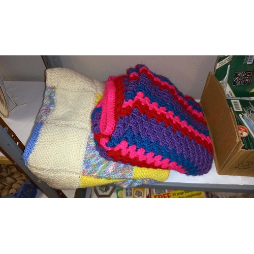 517 - 2 shelves of sewing/knitting/crocheting magazines, plus a knitted blanket, a crocheted blanket, croc... 