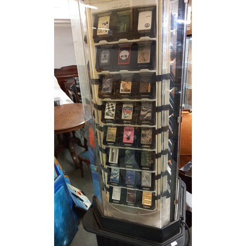 1518 - A Zippo lighters collector's cabinet complete with 100 lighters and magazines. (should revolve but n... 