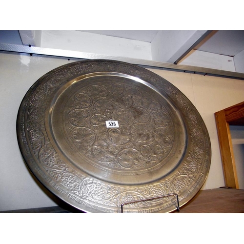 528 - A large silver plated charger wall plate. Diameter approx 50cm   COLLECT ONLY