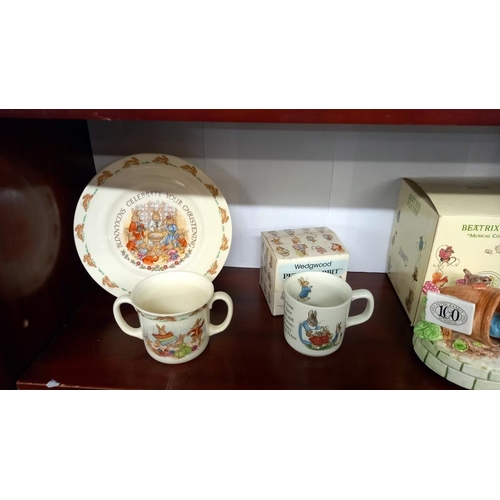 555 - A Pinky and Perky dish and mug, boxed Wedgwood Peter Rabbit mug, a Schmid Beatrix Potter musical Pet... 