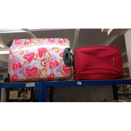 630 - A large suitcase and small red case