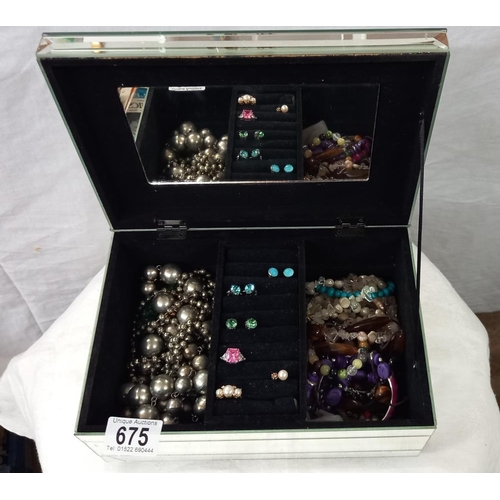 675 - A glass jewellery box and contents