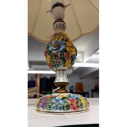 679 - A china table lamp with relief lustre flowers