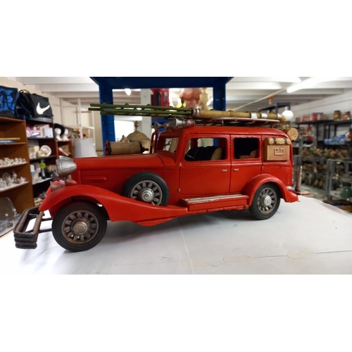 683 - A large pressed steel and fibre glass model of a vintage American fire engine length 36cm