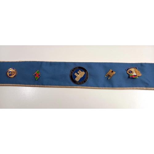 687 - A Lincoln Cathedral guide sash with Lincoln associated badges