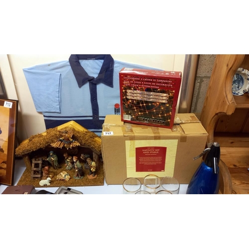 717 - A boxed nativity set and box of Christmas lights (donkey in nativity is a/f)