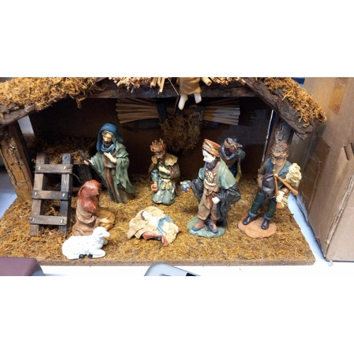 717 - A boxed nativity set and box of Christmas lights (donkey in nativity is a/f)