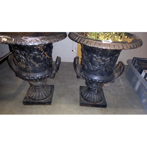 766 - A pair of cast iron garden urns. (Top 37.50 cm Diameter, Base 18.50 cm x 18.50cm. Height 47.50 cm.) ... 