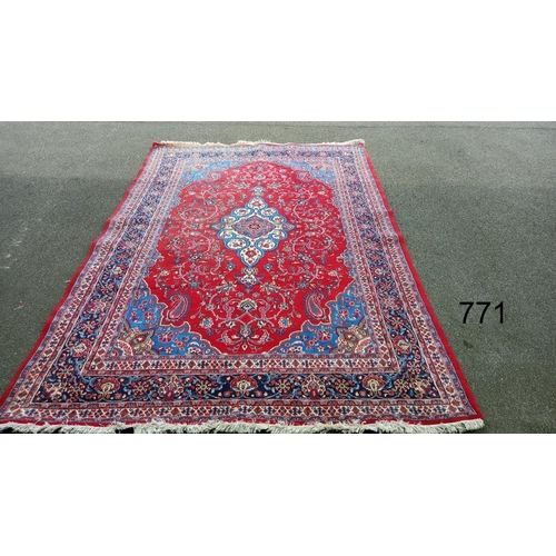 771 - A red patterned rug, 128