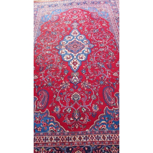 771 - A red patterned rug, 128