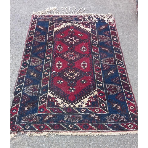 773 - A blue/red patterned rug, 76