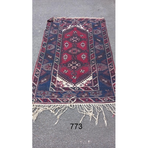 773 - A blue/red patterned rug, 76