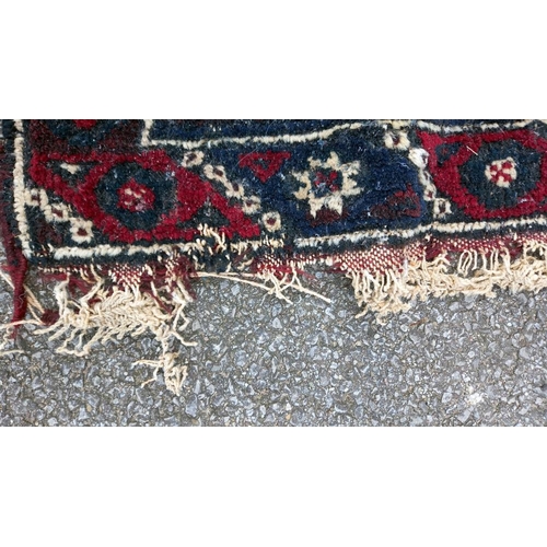 773 - A blue/red patterned rug, 76