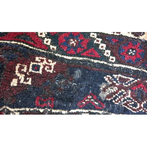 773 - A blue/red patterned rug, 76