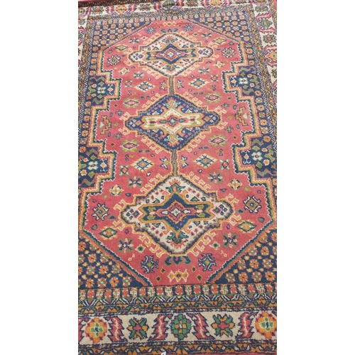 774 - A red patterned rug,  86