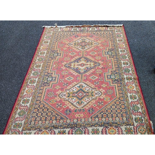 774 - A red patterned rug,  86