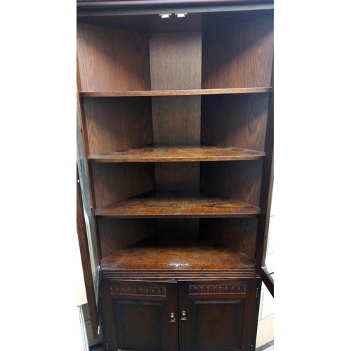 869 - A dark oak corner cupboard with leaded glass doors COLLECT ONLY