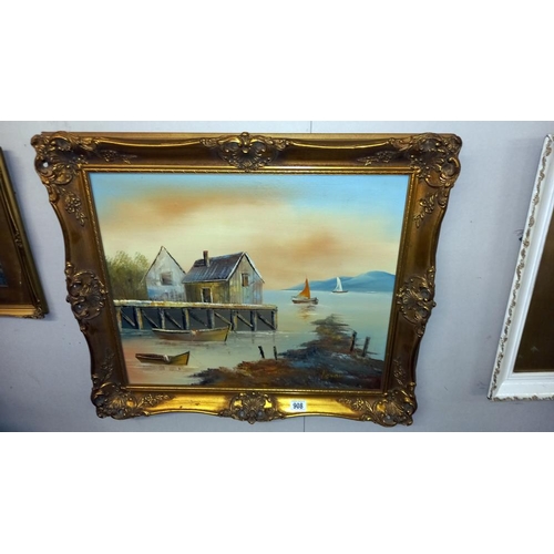 908 - A gilt framed painting on board of sailing boats on water next to boat house COLLECT ONLY