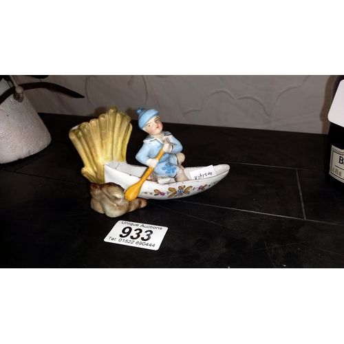 933 - A continental glazed bisque match striker of a boy in a rowing boat