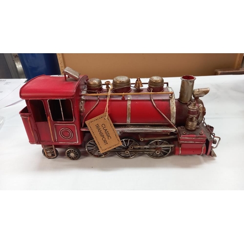 29 - A pressed steel tinplate model ornament of a steam train length 33cm