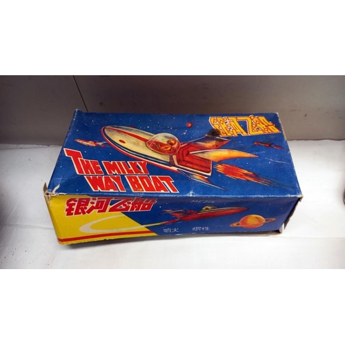 53 - A boxed tinplate The Milky Way boat MF215, made in China and a vintage space gun