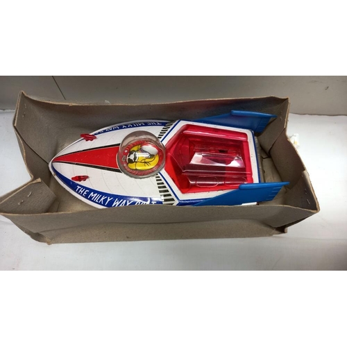 53 - A boxed tinplate The Milky Way boat MF215, made in China and a vintage space gun