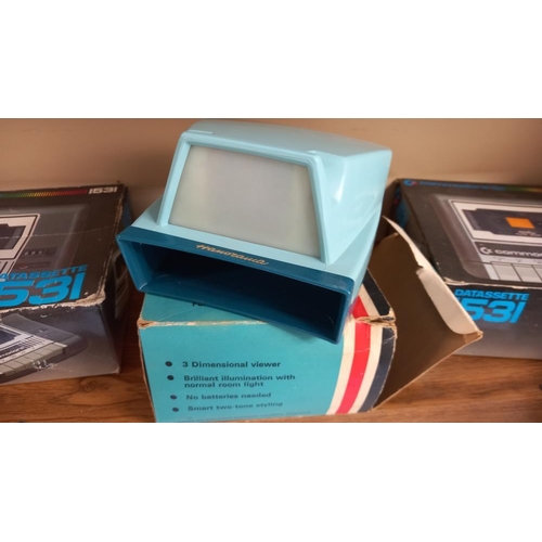 86 - 2 boxed commodore datassette cassette players and a Hanimex Hanorama slide viewer