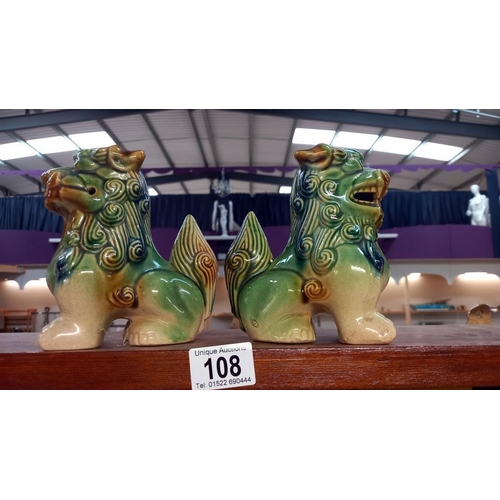 108 - A pair of glazed stoneware Chinese dogs of Foo